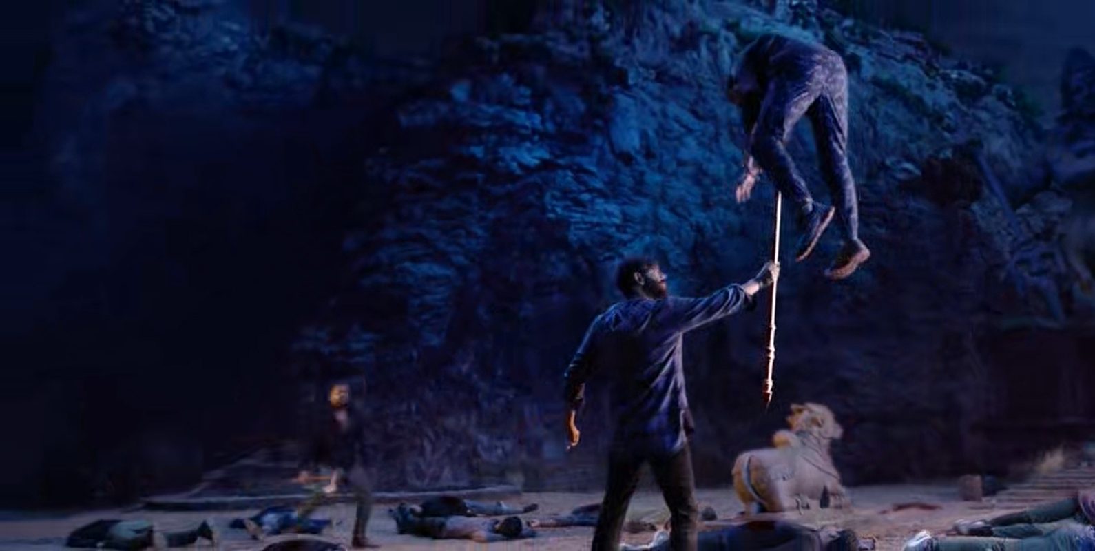 A man flips an opponent with a spear in a blue-lit temple