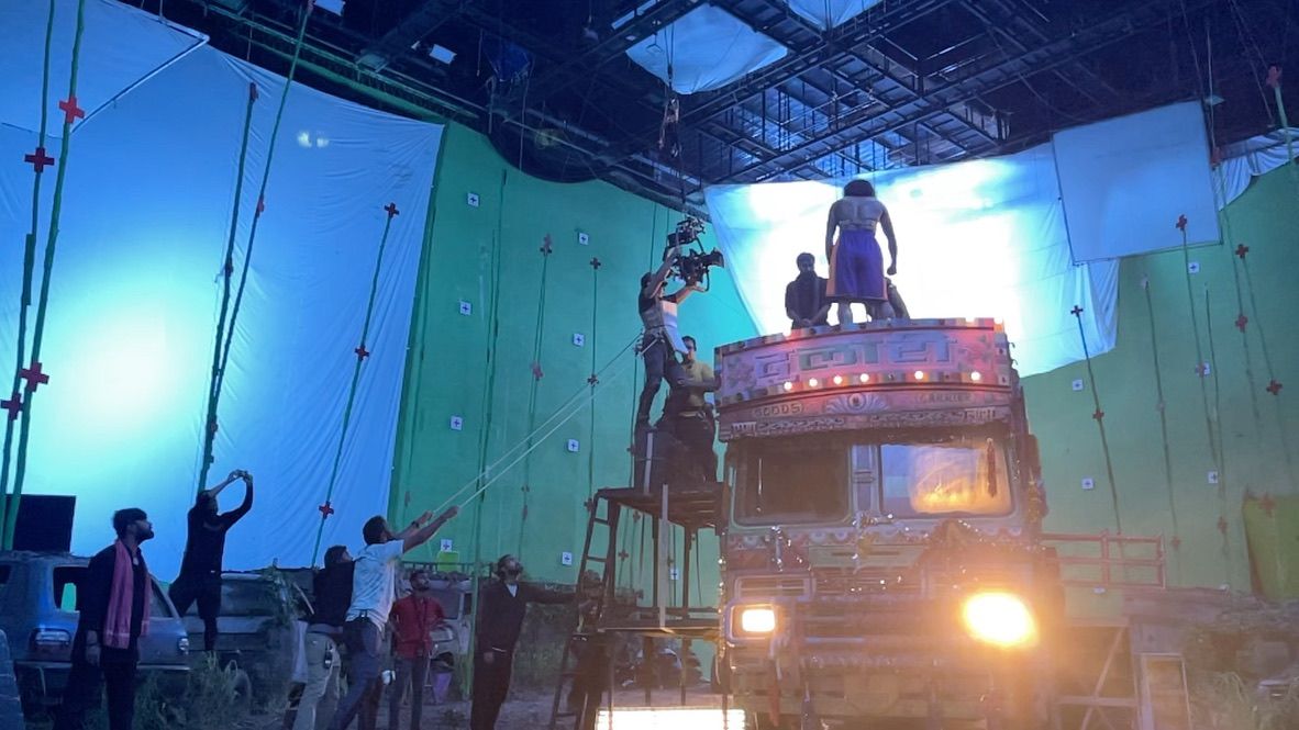 Behind the scenes: The truck on a greenscreen stage, camera on a scaffold above it