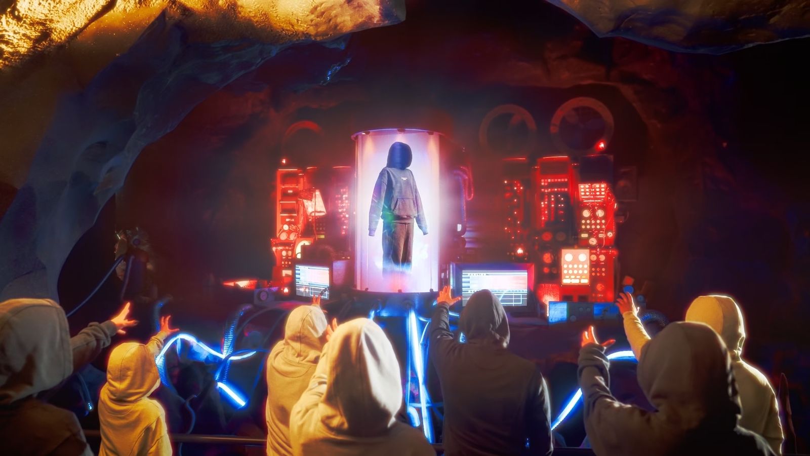 Hooded figures reach towards a glowing capsule in a cave