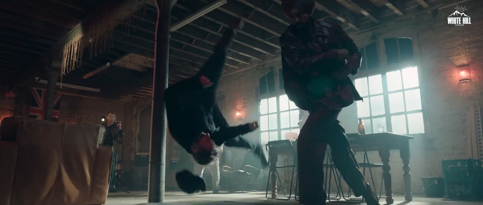 Fight scene in a backlit warehouse