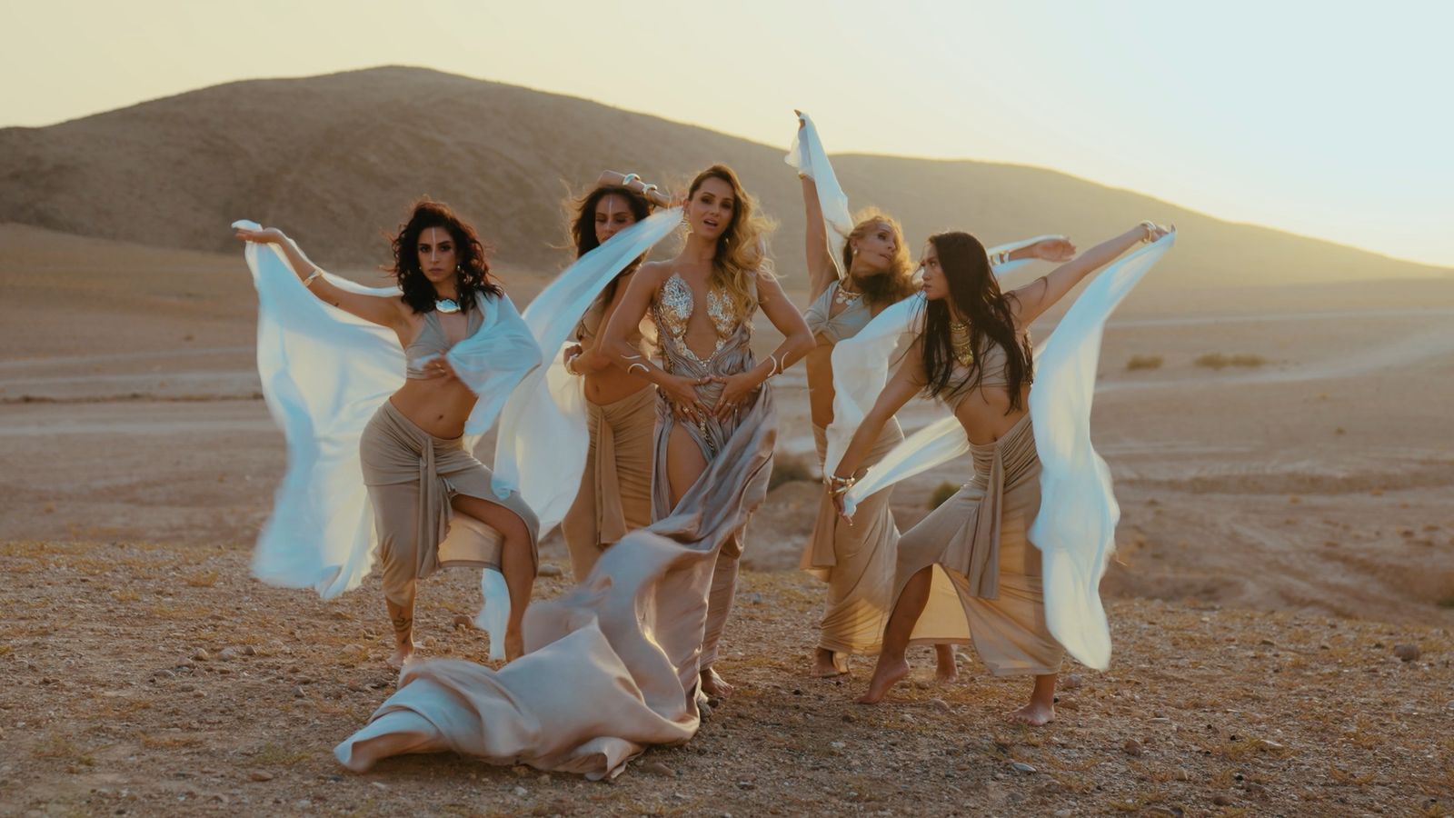 Julia and four dancers with flowing white fabric in the desert