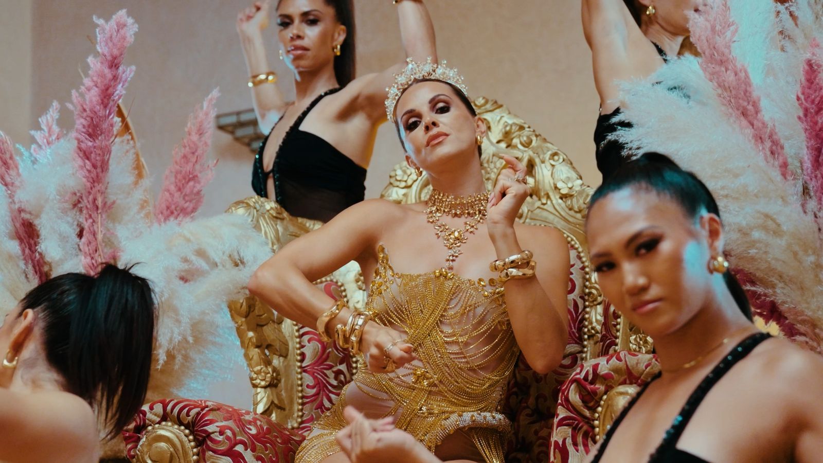 Julia on a golden throne surrounded by dancers