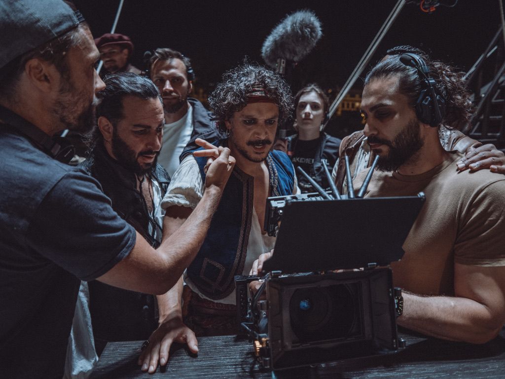 Checking the shot at the monitor with the director and cast