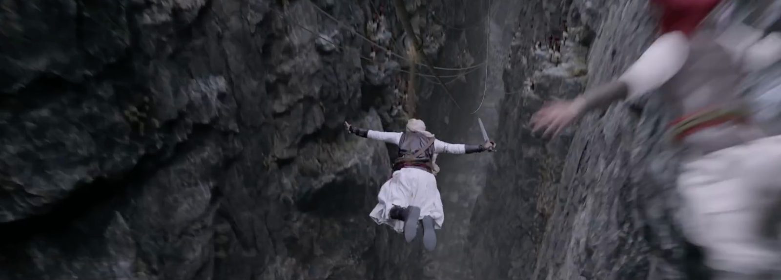 A warrior leaps into a rocky gorge